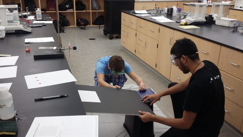 Students complete a fictional forensics lab with blood stain splatters as part of a linked cohort course.