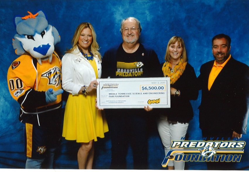 Murphree accepts check from the Nashville Predators