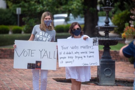 Two Belmont employees hold signs during celebration