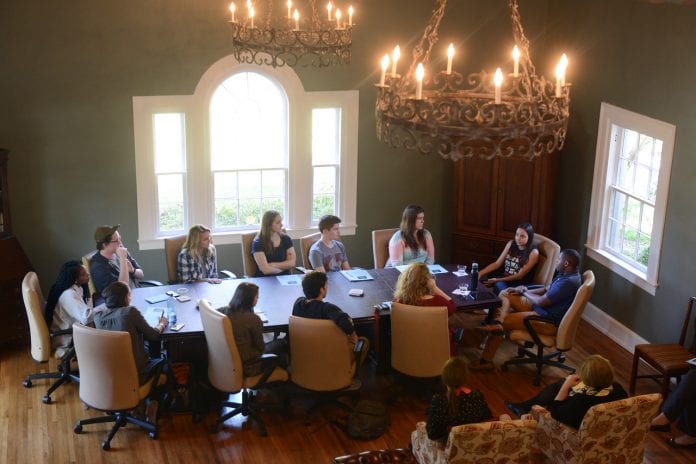 Students sit with Hart and Clark at the first entertainment roundtable