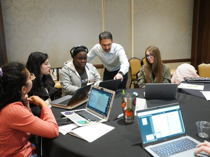 people collaborate around computers